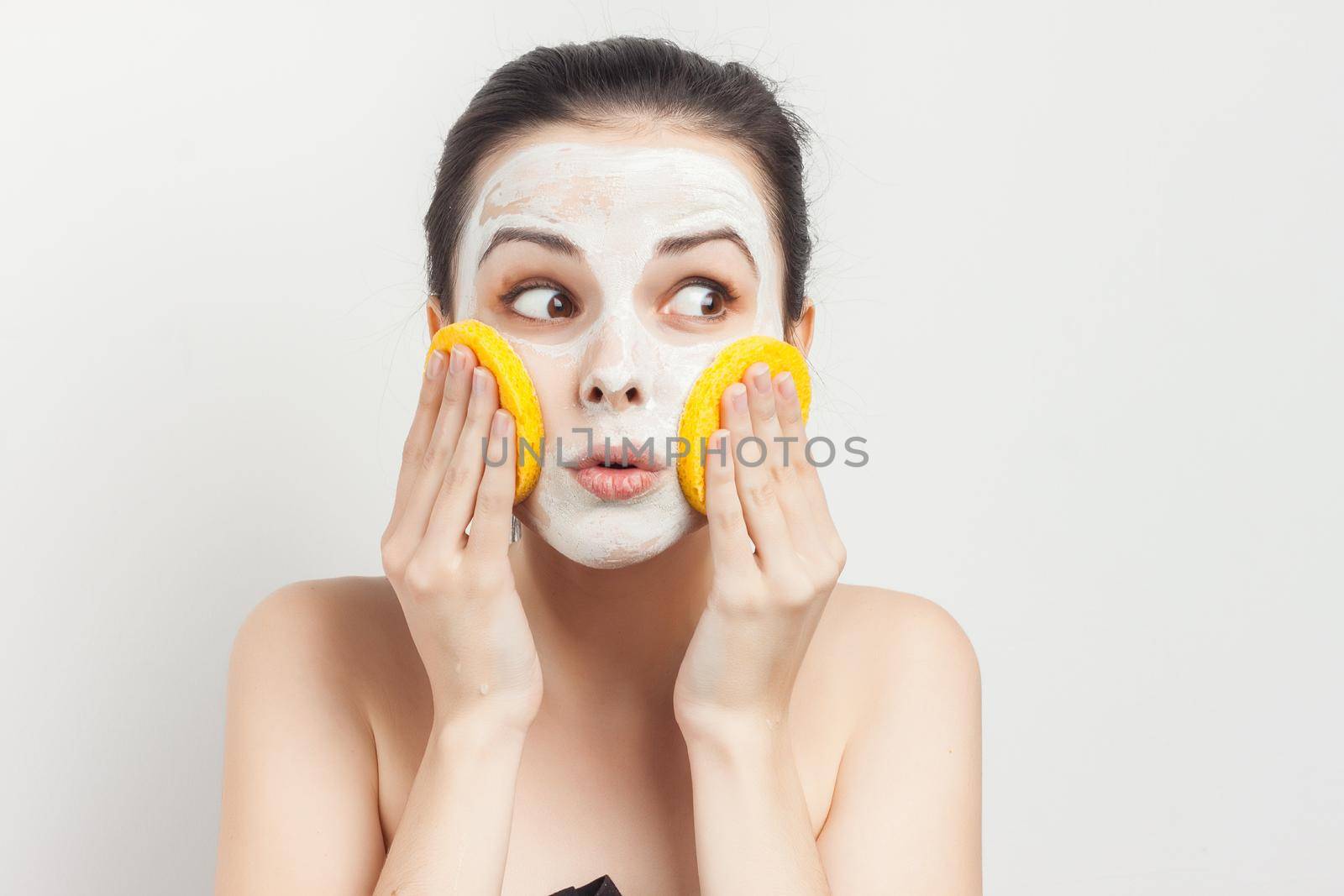 woman with bare shoulders face cream makeup skin care. High quality photo