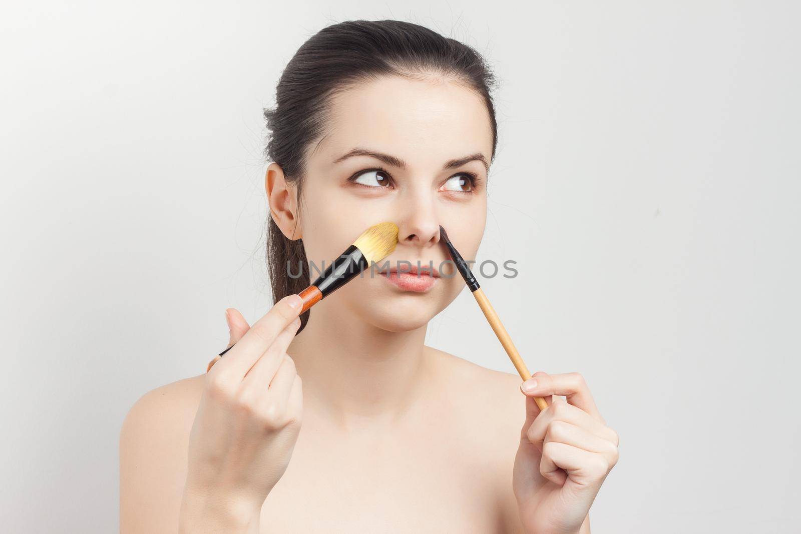 woman with bare shoulders face cream makeup skin care. High quality photo