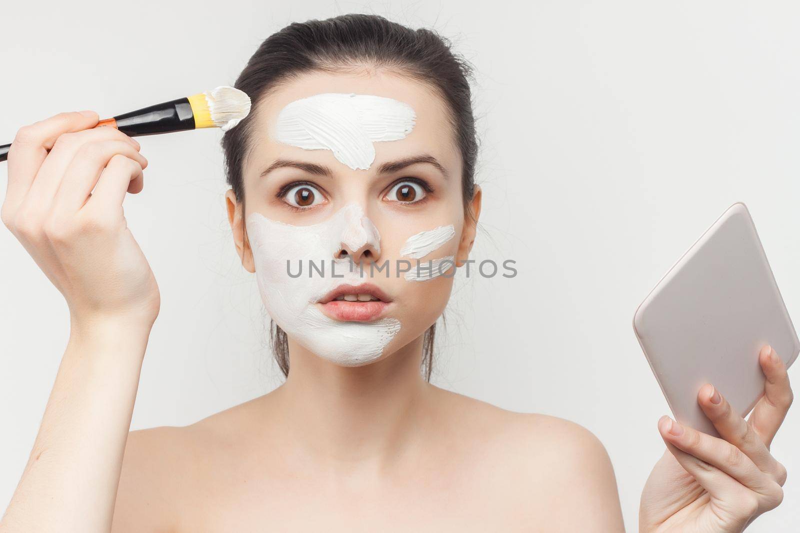 woman with bare shoulders face cream makeup skin care. High quality photo