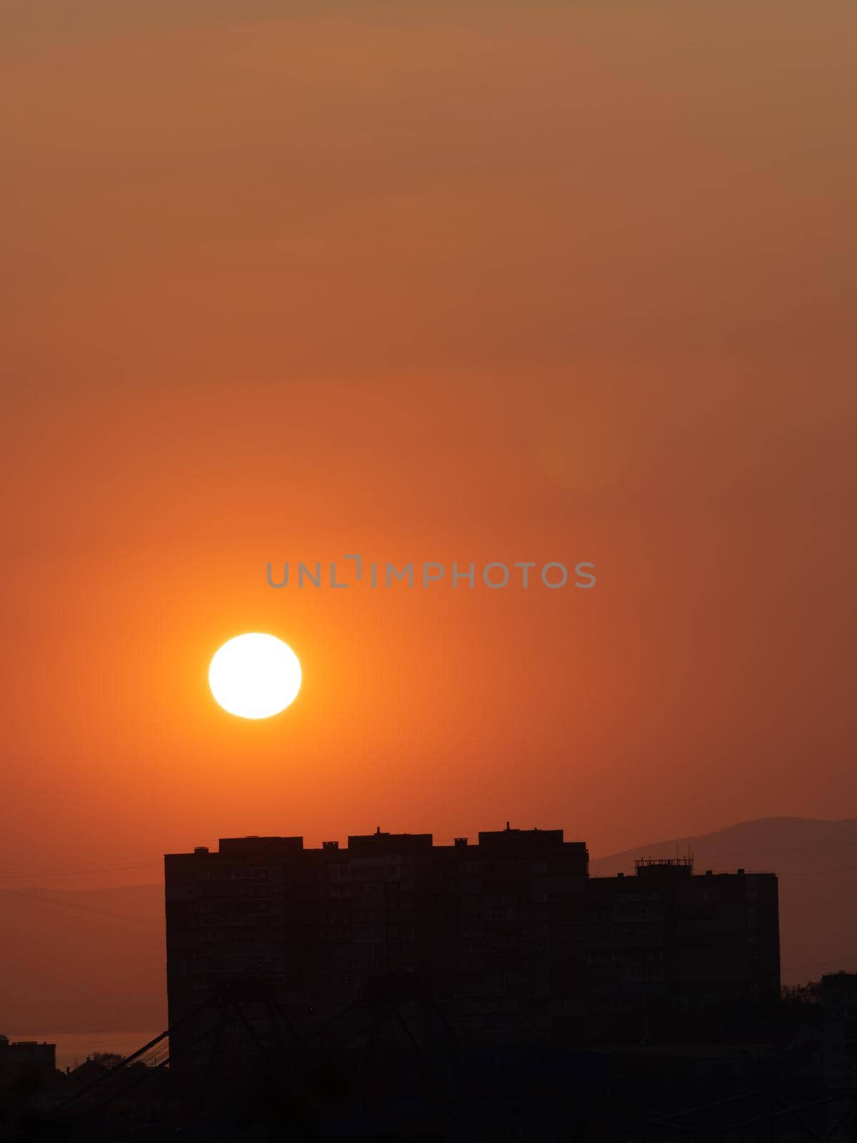 Orange sunset over the city. Vladivostok, Russia