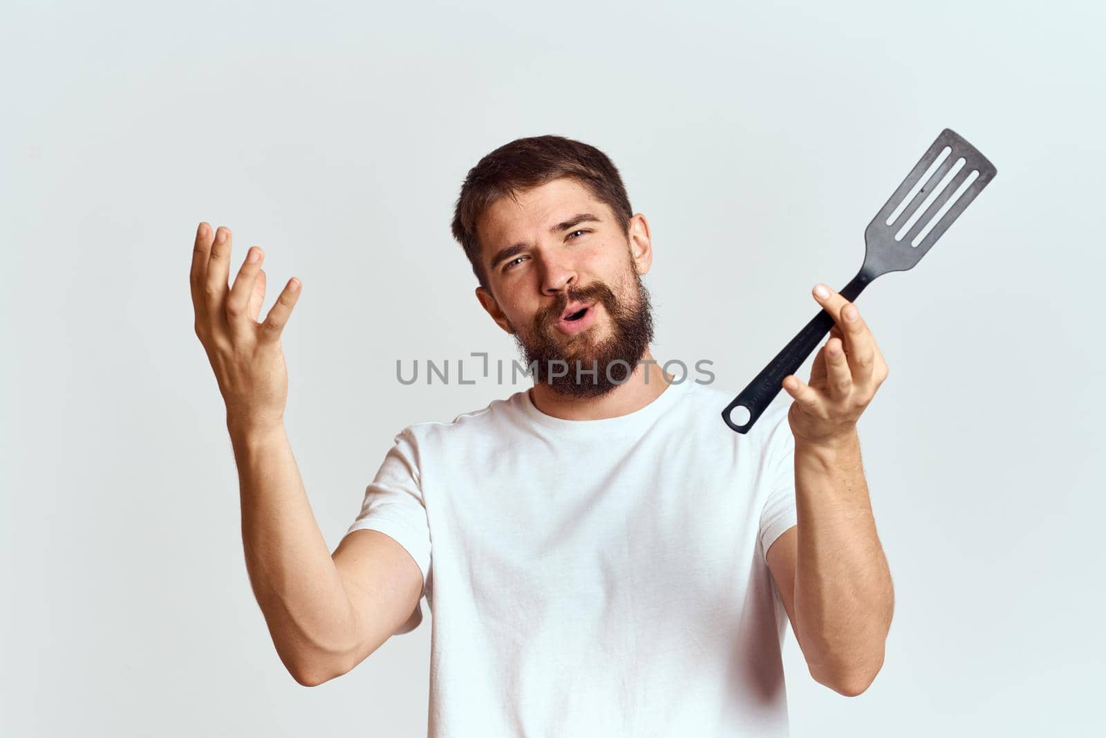 bearded man kitchenware cooking food cropped view. High quality photo