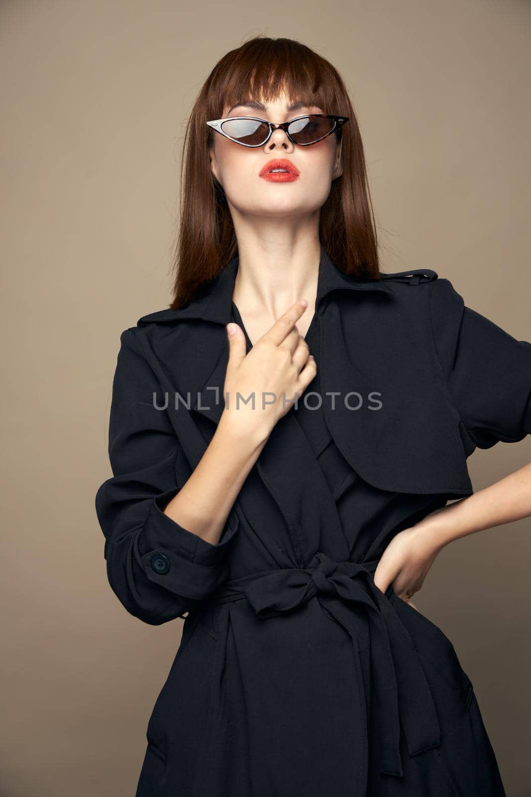 Pretty Woman touches her neck with her hand short hairstyle beige isolated background Copy spaces