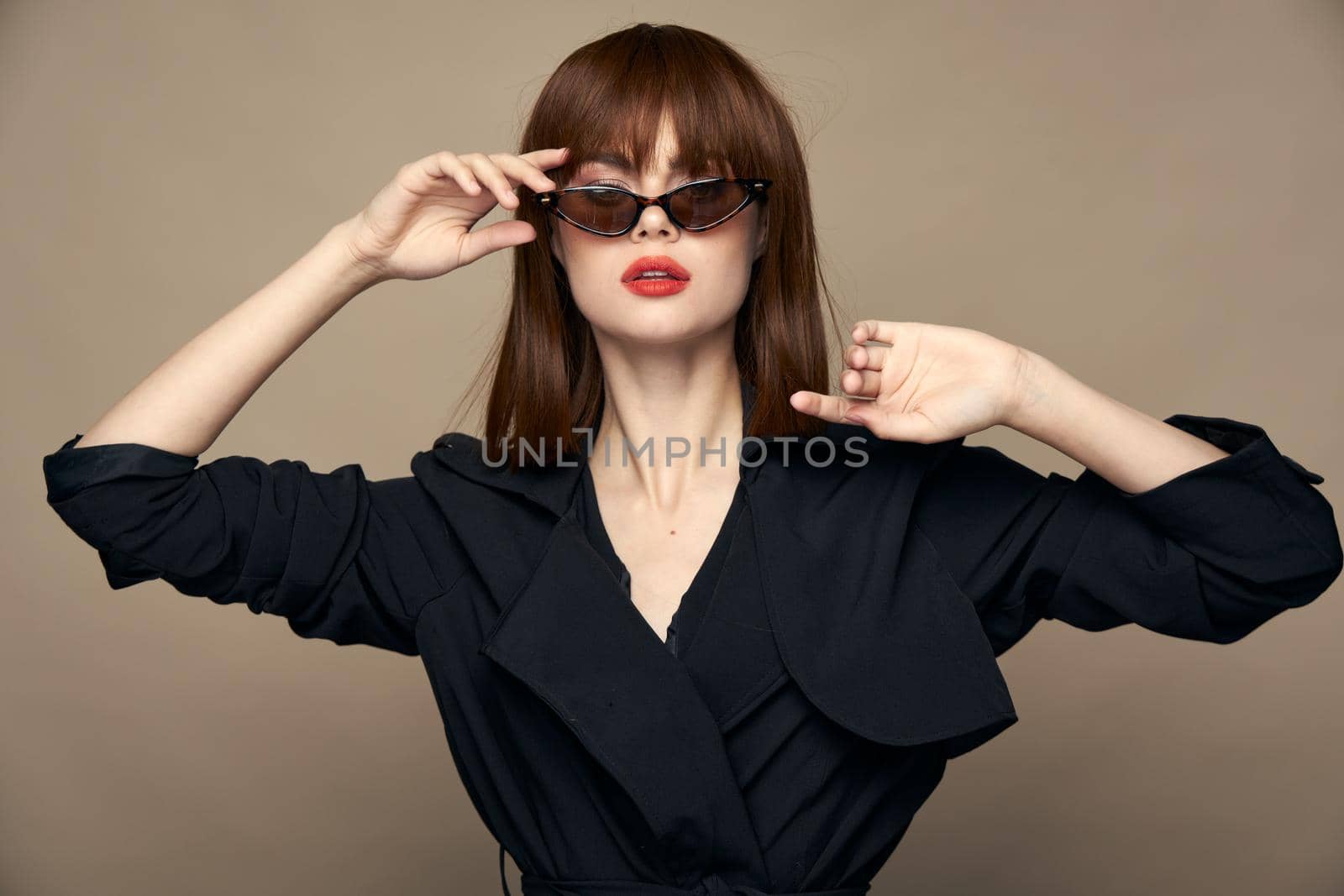 Charming brunette Correct the glasses on the face elegant appearance isolated background