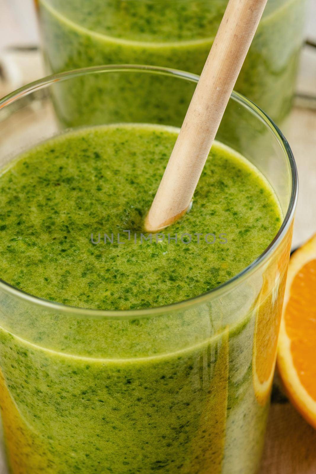 Healthy green smoothie with spinach, mango, orange,lime, apple,citrone in glass jars.