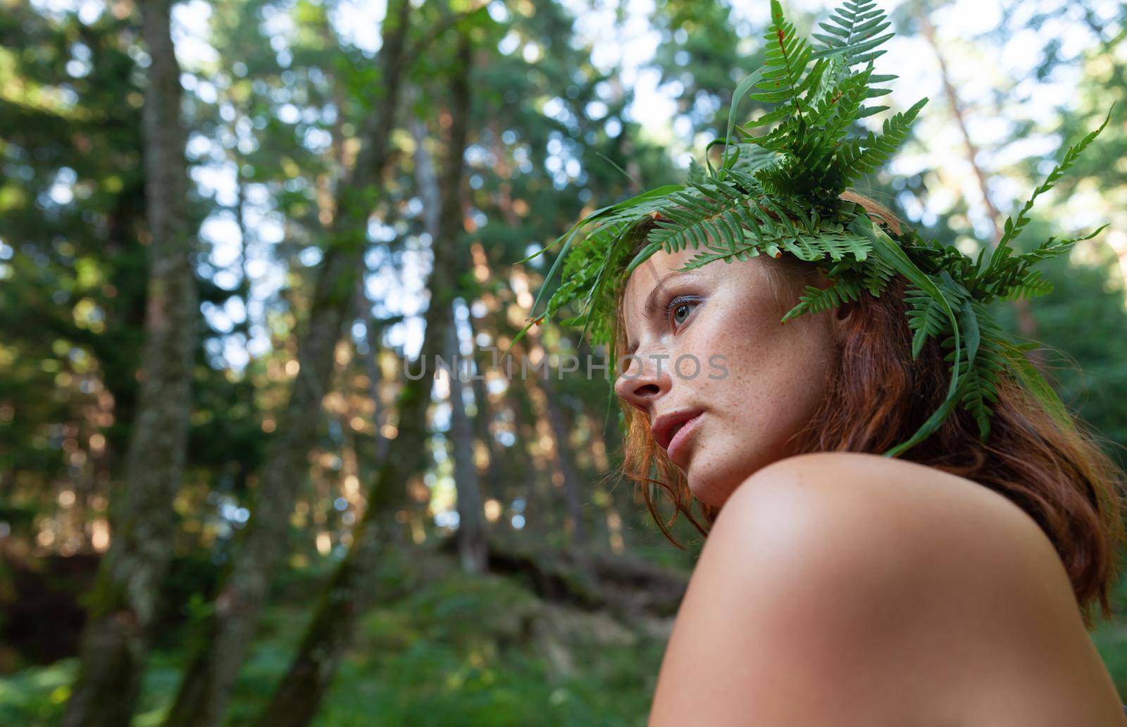 Nude woman with fern wreath in the forest river by palinchak