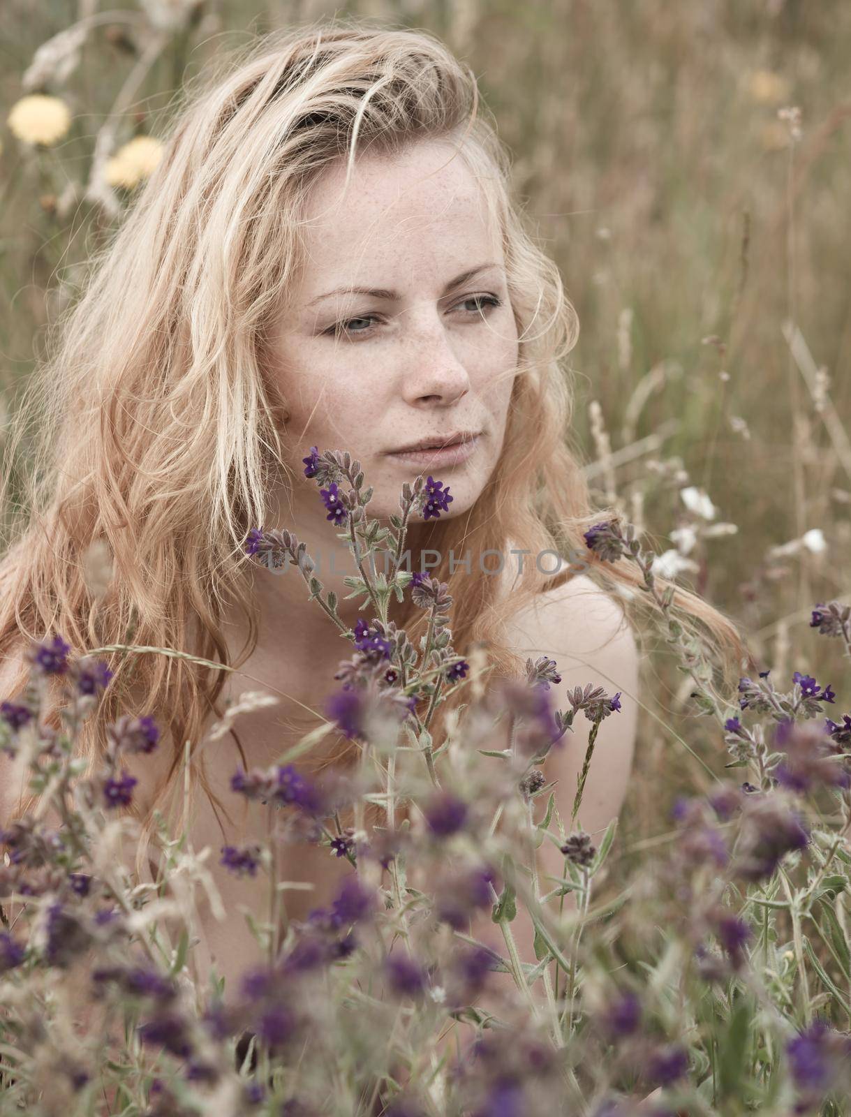 Artistic portrait of freckled woman on natural background by palinchak