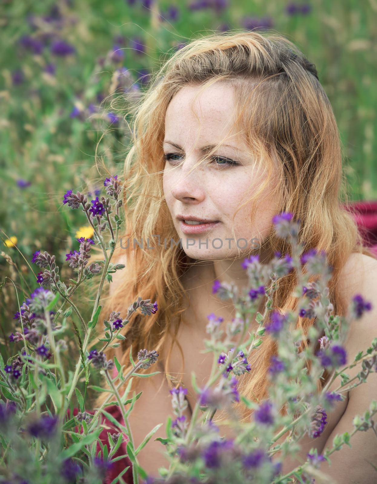 Artistic portrait of freckled woman on natural background by palinchak