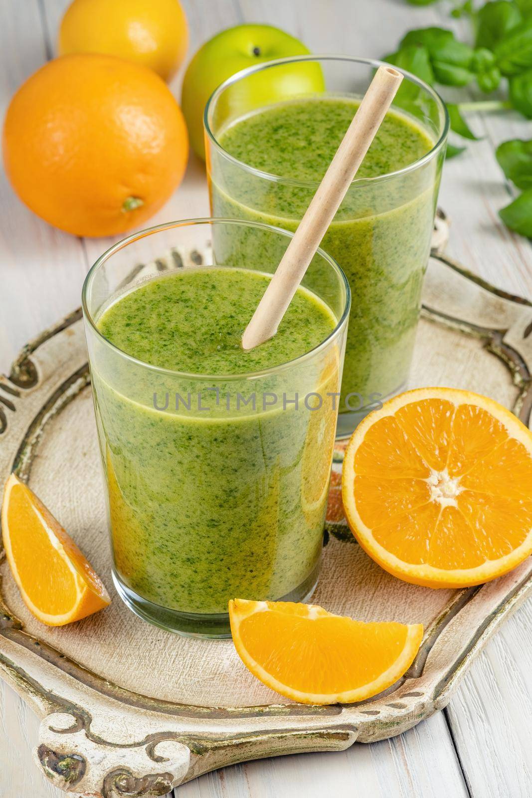 Healthy green smoothie with spinach, mango, orange,lime, apple,citrone in glass jars.