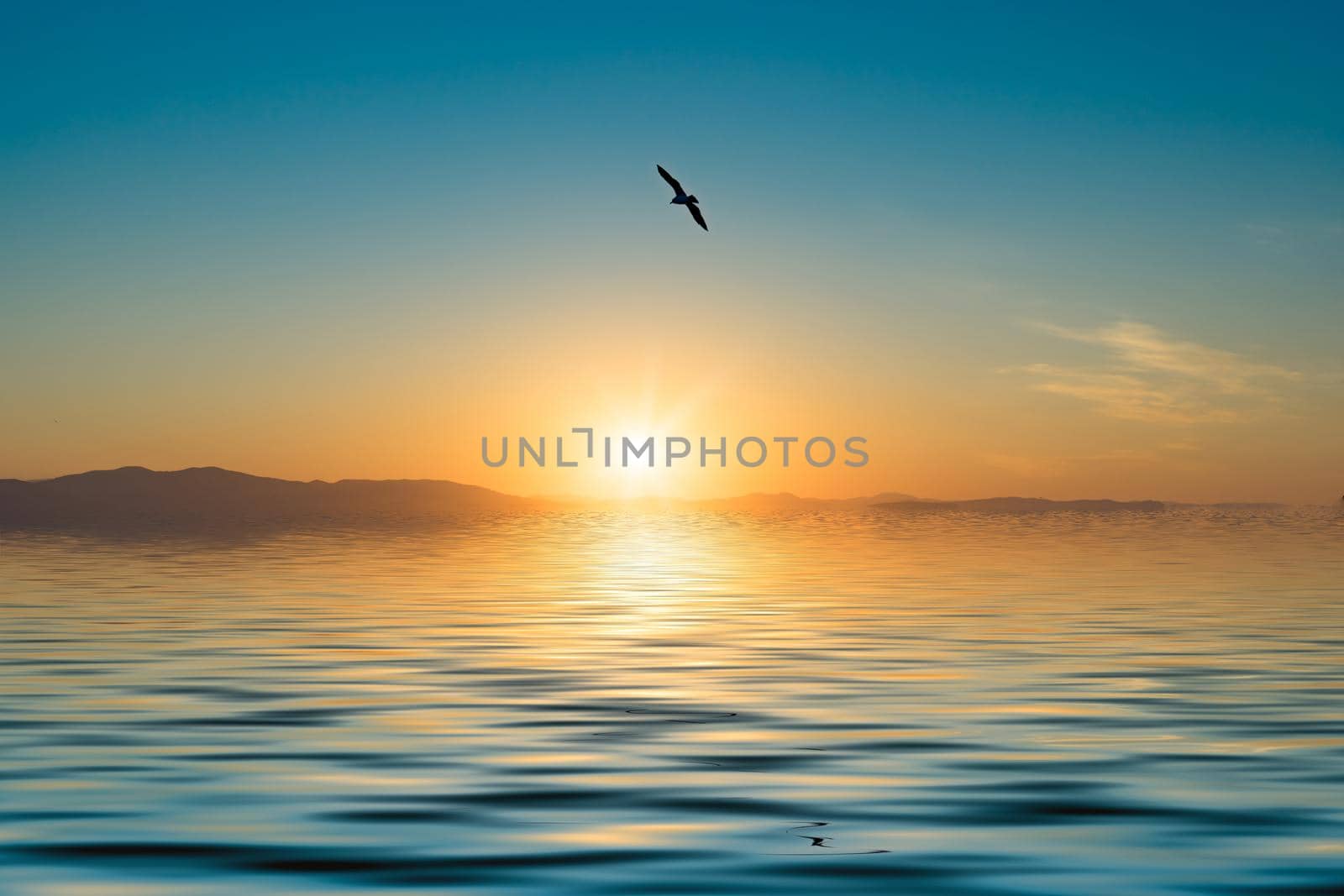 Seascape with a bright sunset reflected in the water surface.