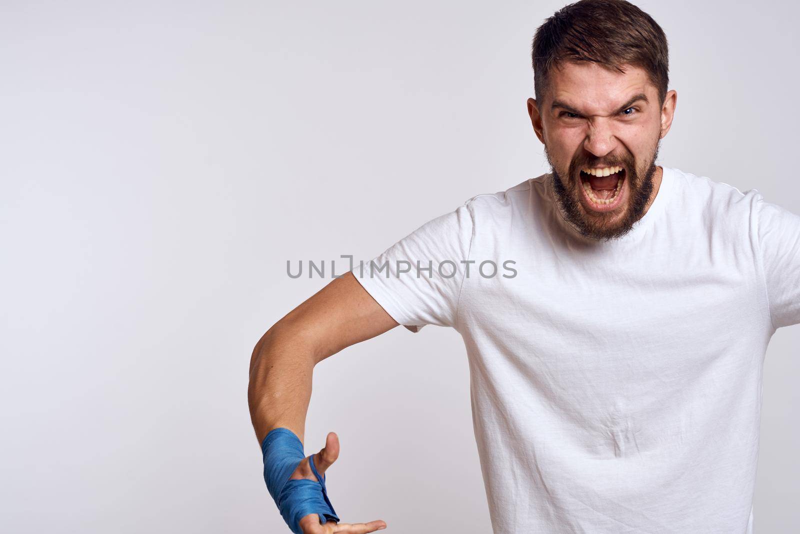 Sports man boxing bandages on hands emotions energy workout. High quality photo