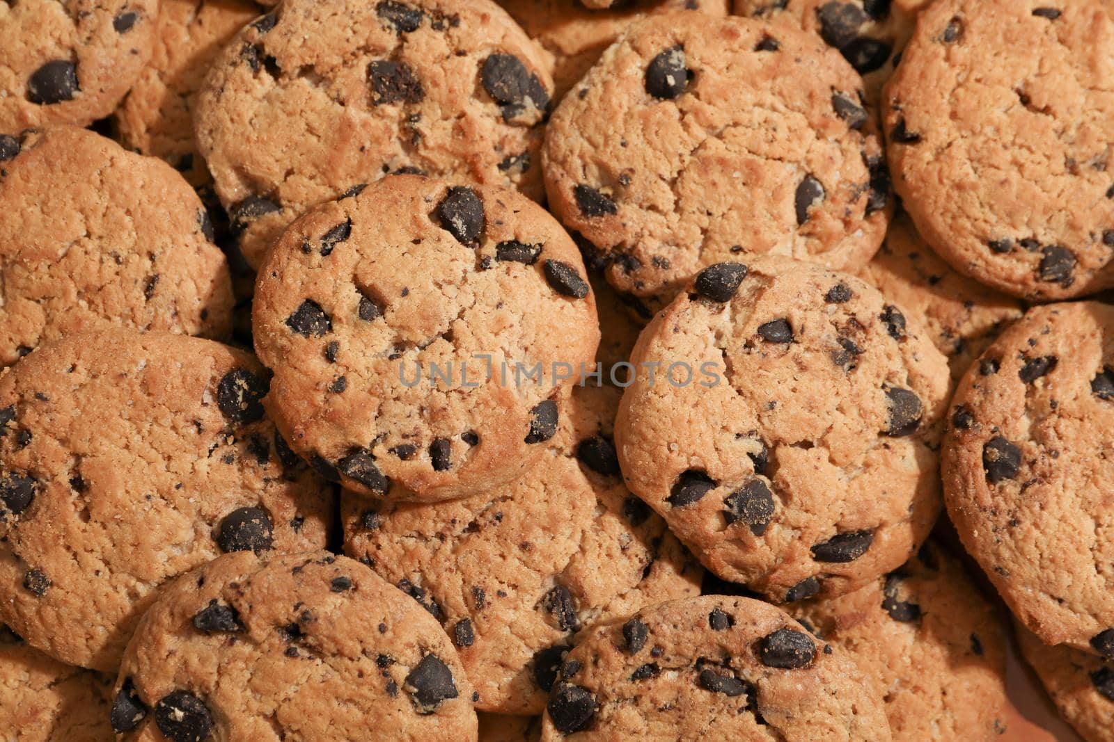 Tasty chocolate chip cookies as background, top view by AtlasCompany