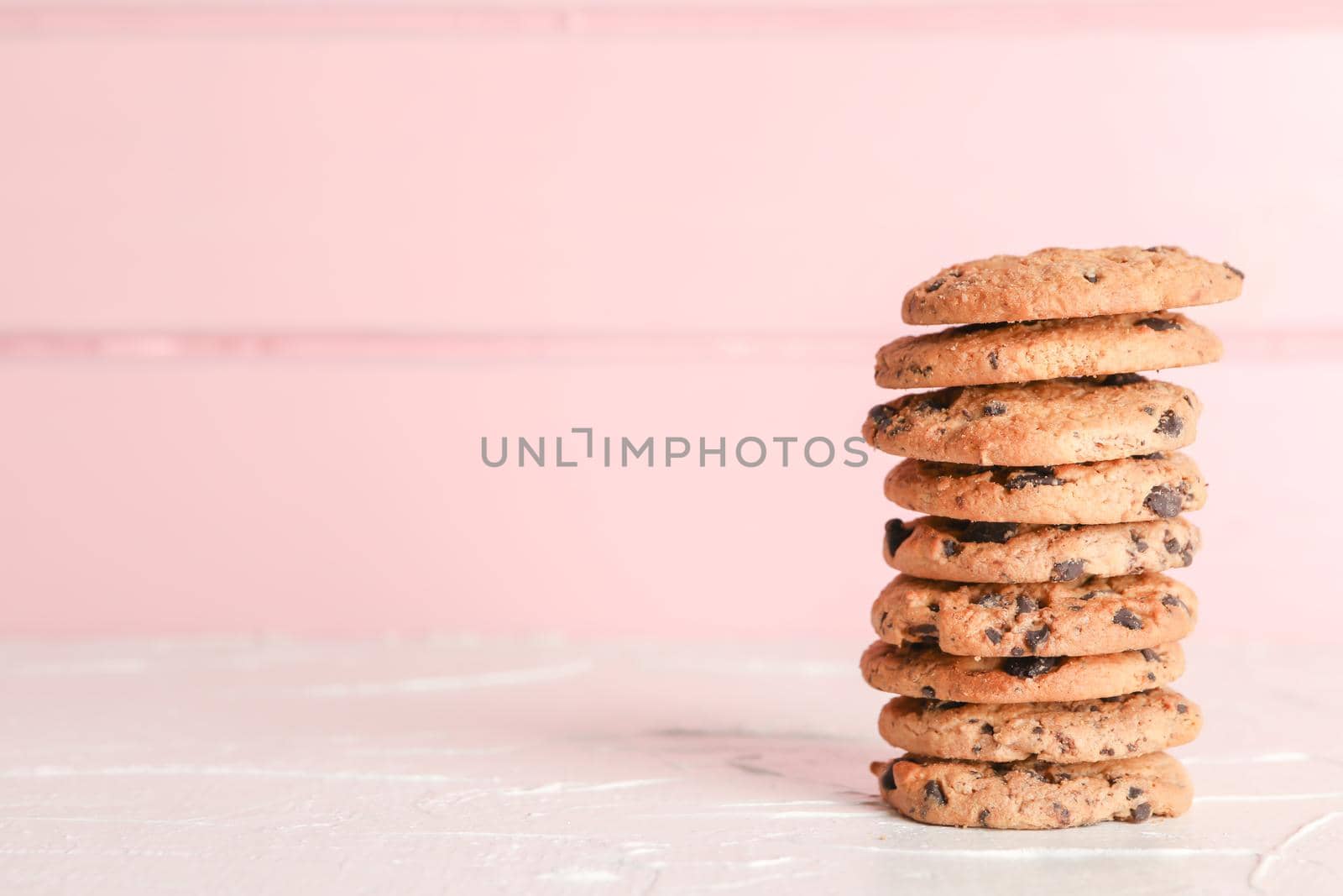 Stack of tasty chocolate chip cookies on wooden background. Space for text by AtlasCompany