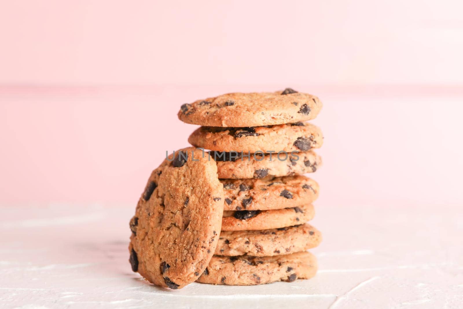 Stack of tasty chocolate chip cookies on wooden background. Space for text by AtlasCompany