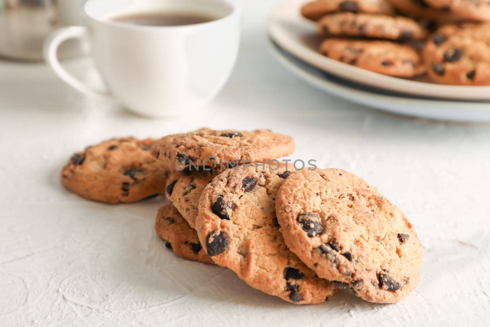 Homemade chocolate chip cookies on gray background, closeup