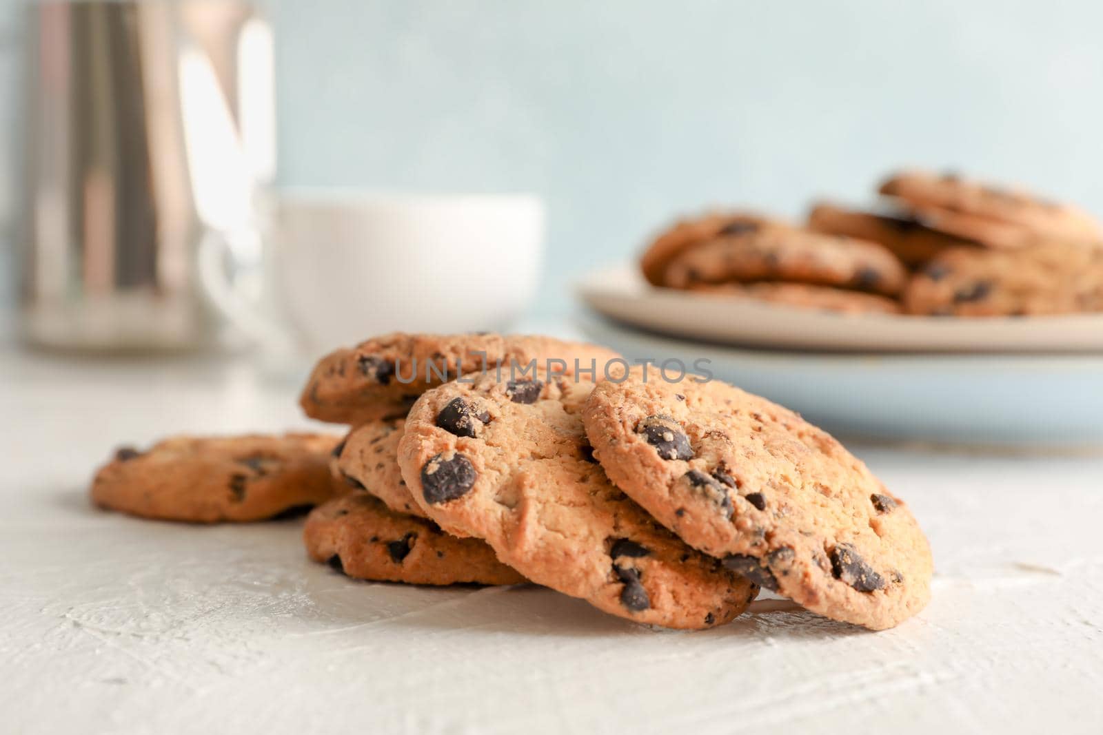 Homemade chocolate chip cookies on gray background, closeup