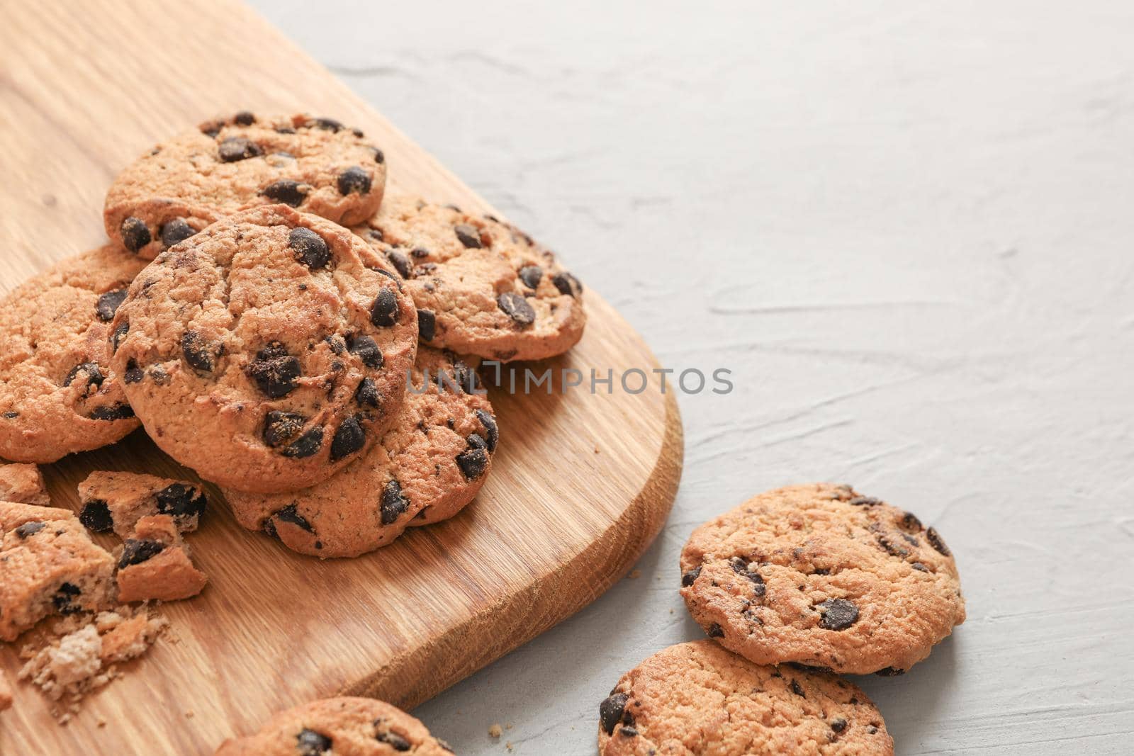 Tasty homemade chocolate chip cookies on gray background by AtlasCompany