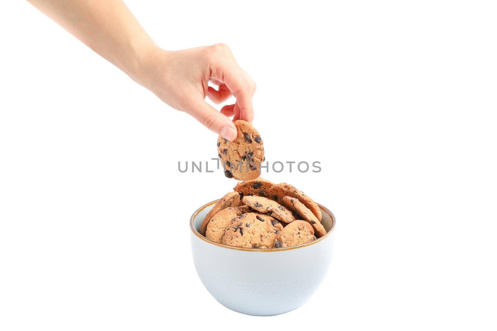 Young woman holding tasty chocolate chip cookie over bowl on white background, closeup by AtlasCompany