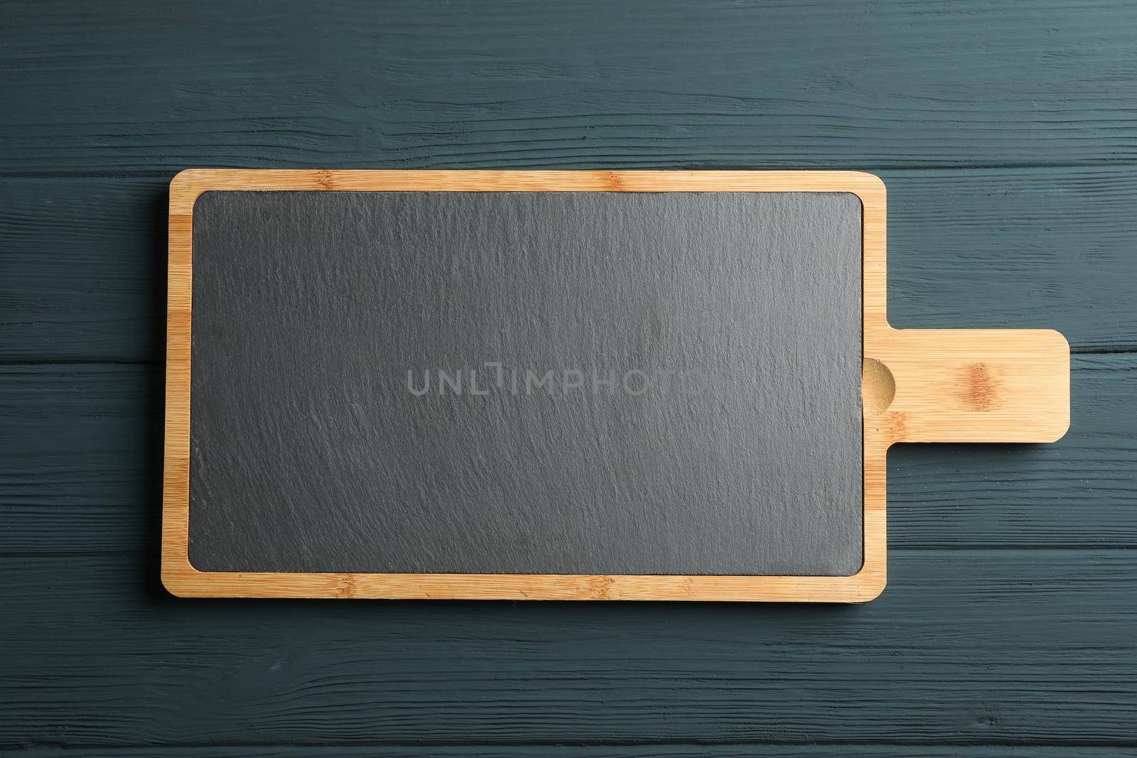 Cutting board on wooden background, space for text by AtlasCompany