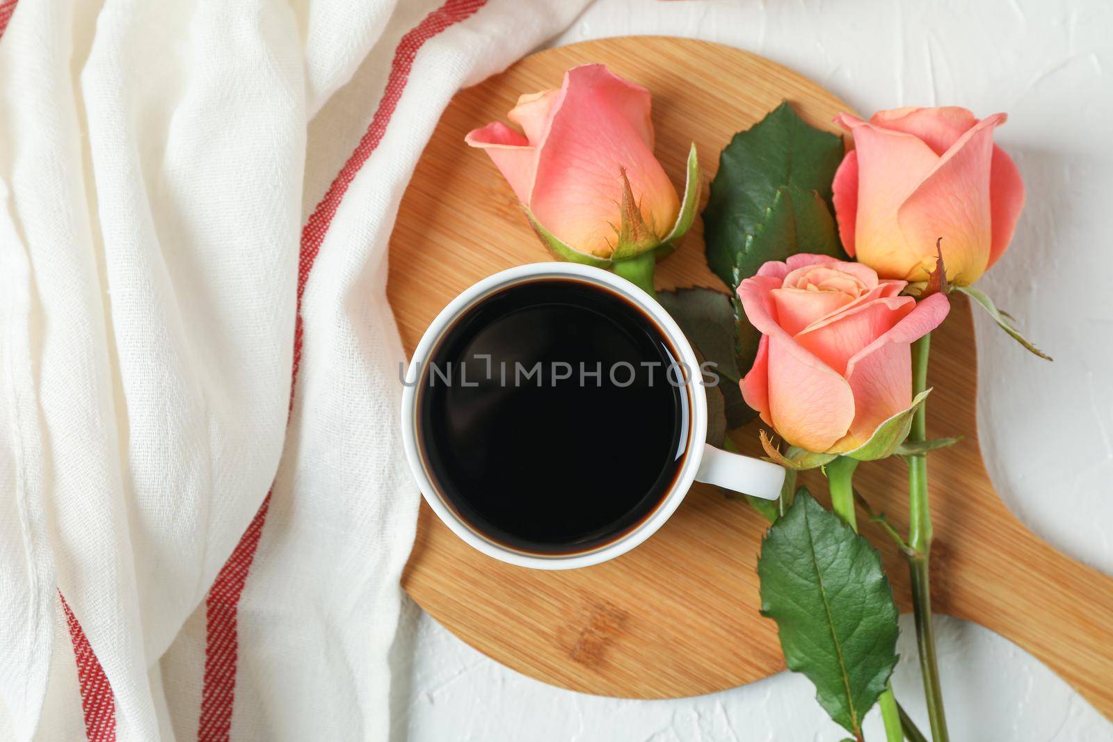 Composition with cup of coffee, roses and kitchen towel on white background, top view by AtlasCompany