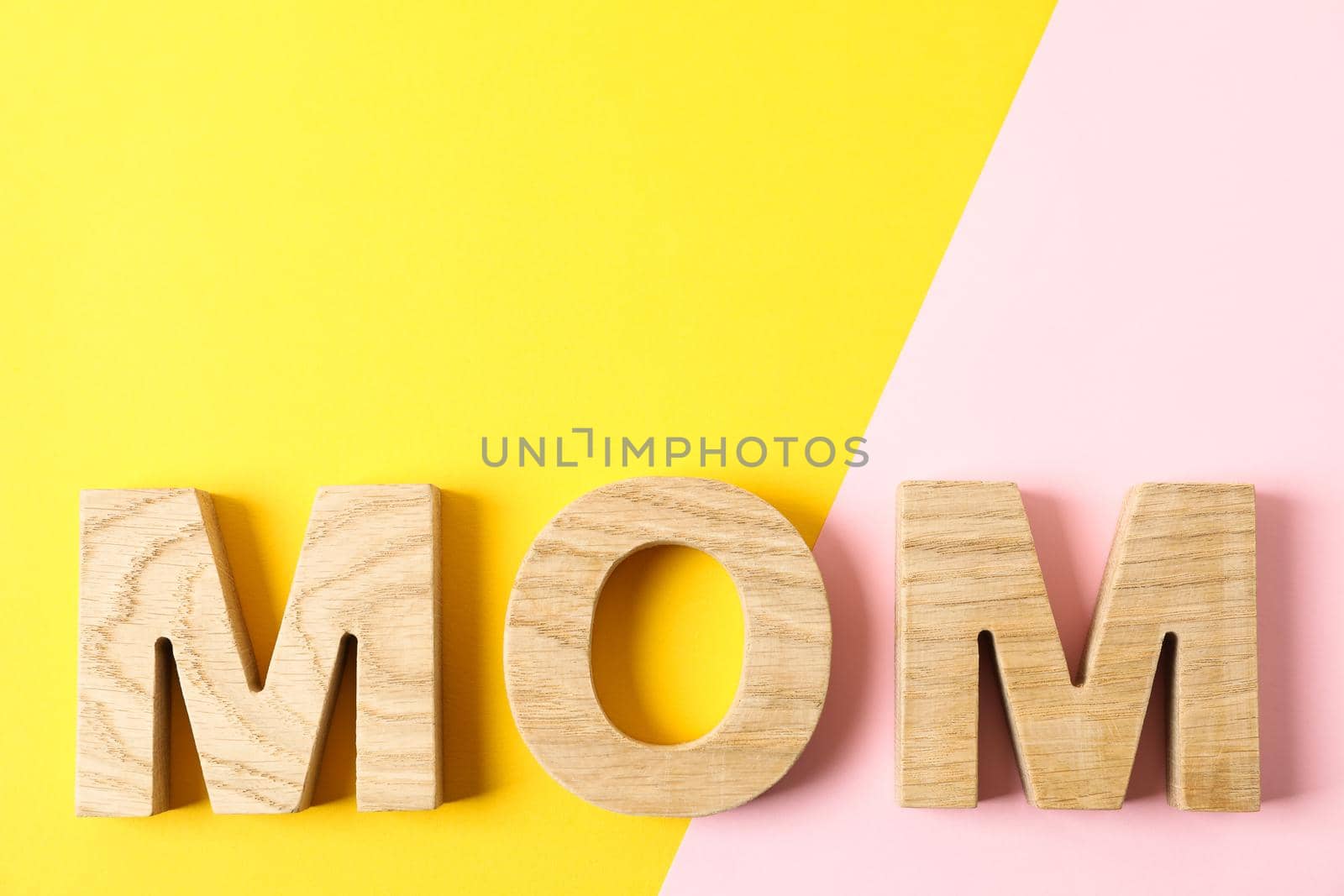 Inscription mom with space for text on two tone background, top view by AtlasCompany