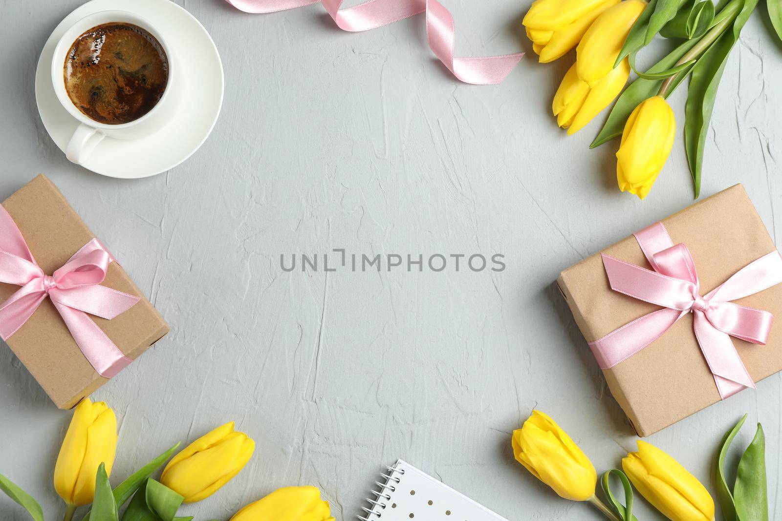 Beautiful yellow tulips and accessories on grey background, space for text. Blogger concept