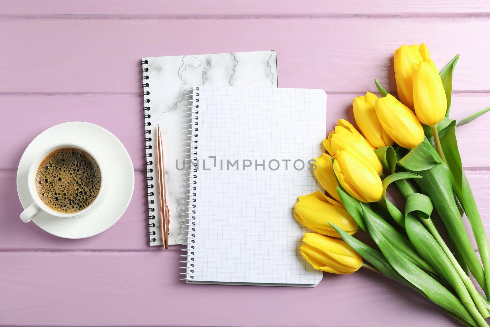 Beautiful yellow tulips and accessories on wooden background. Blogging concept