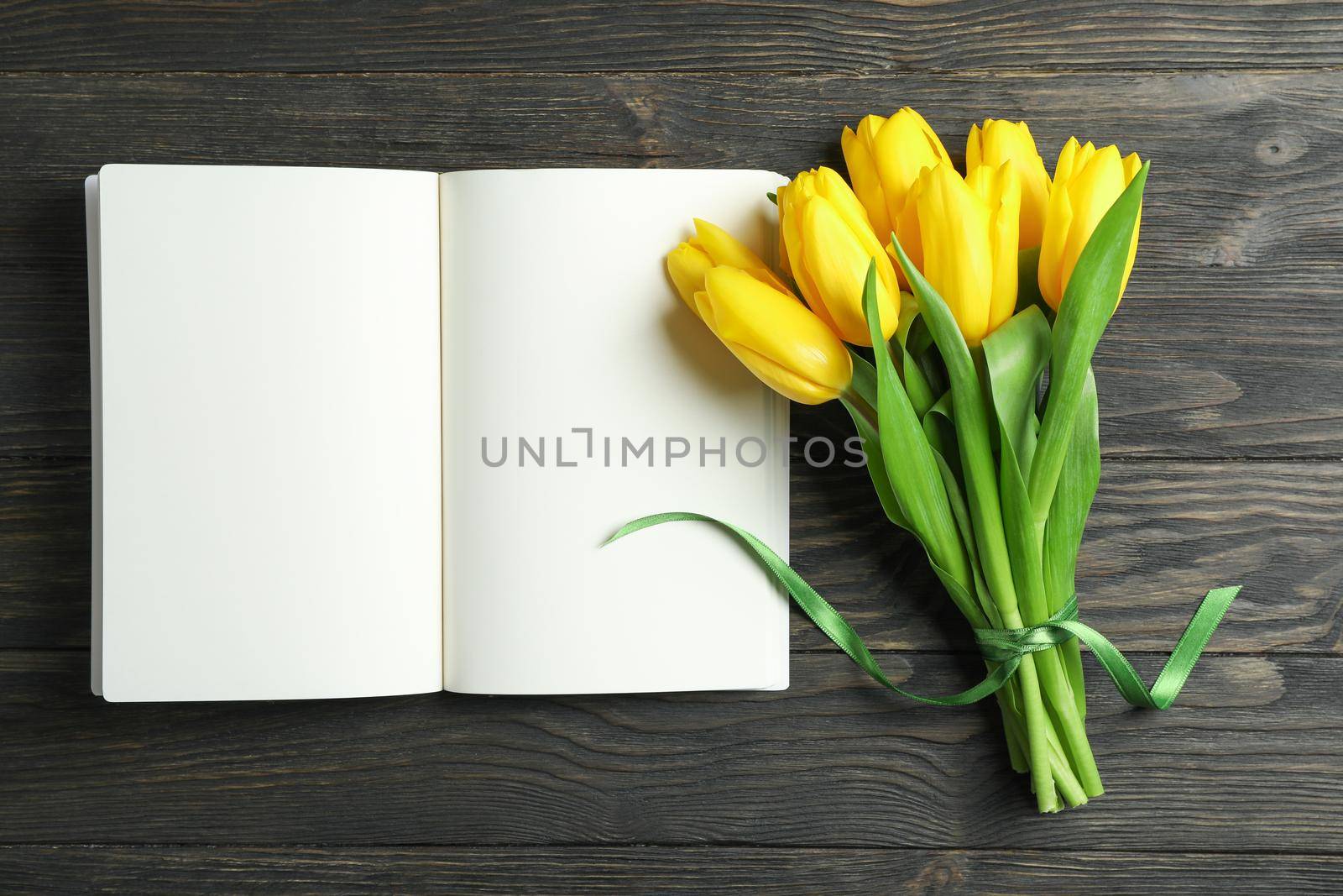 Beautiful yellow tulips and accessories on wooden background, space for text. Blogging concept