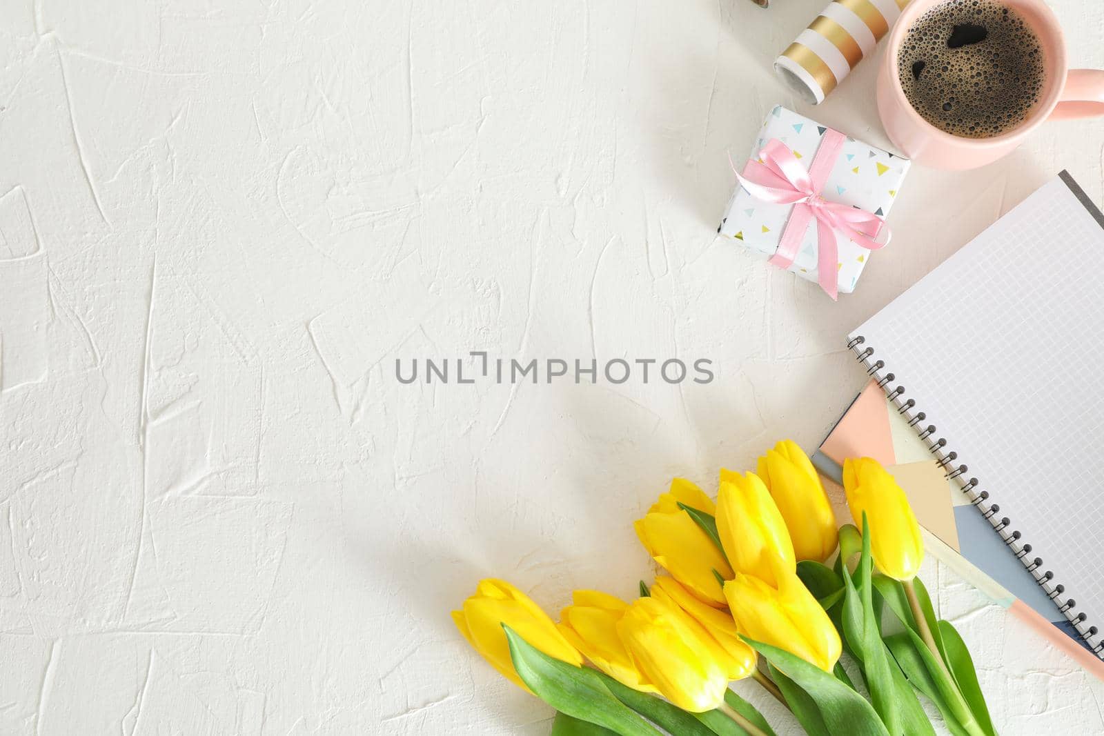 Beautiful yellow tulips and accessories on light background, space for text. Top view