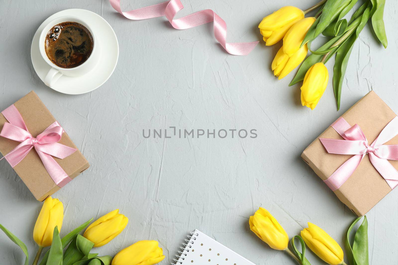 Beautiful yellow tulips and accessories on grey background, space for text. Blogging concept