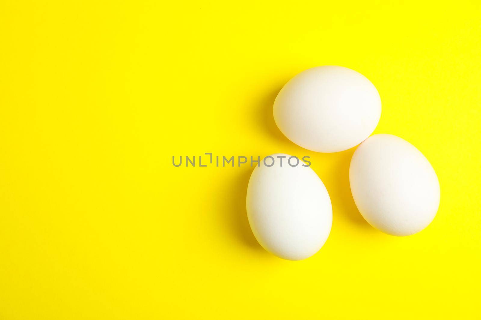 Chicken eggs on color background, space for text by AtlasCompany