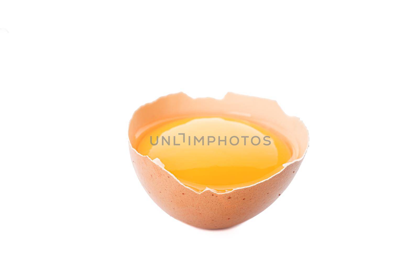 Half broken egg with yolk isolated on white background