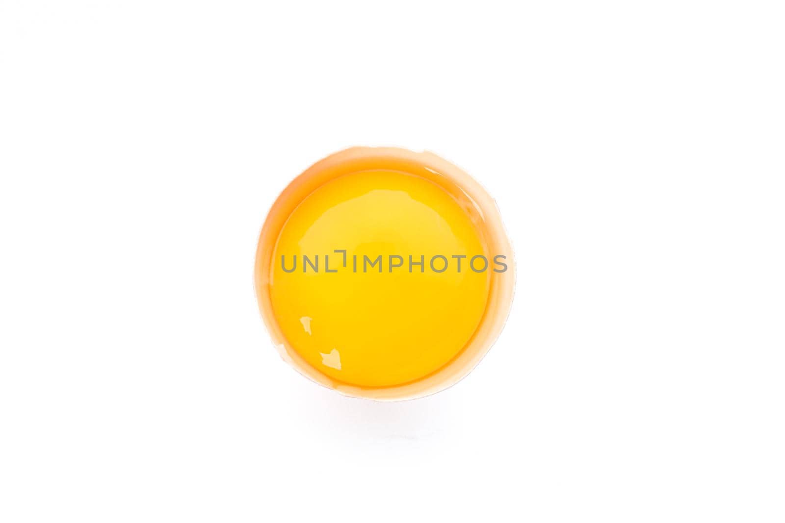 Half broken egg with yolk isolated on white background, top view