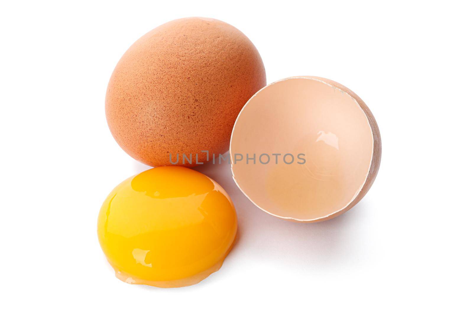 Whole egg, half eggshell and egg yolk isolated on white background