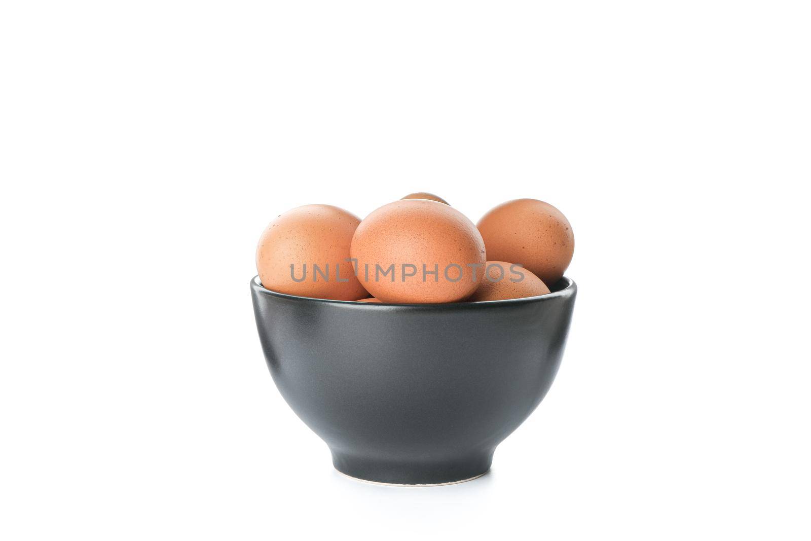 Brown chicken eggs in bowl isolated on white background