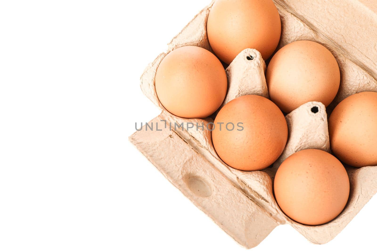 Brown chicken eggs in carton box isolated on white background, top view