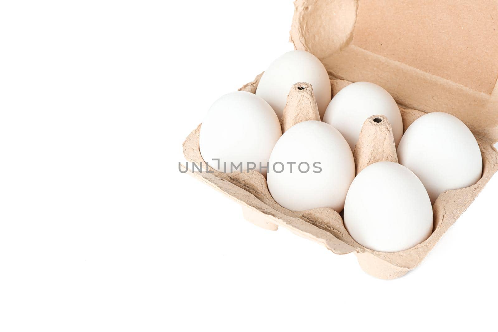 White chicken eggs in carton box isolated on white background