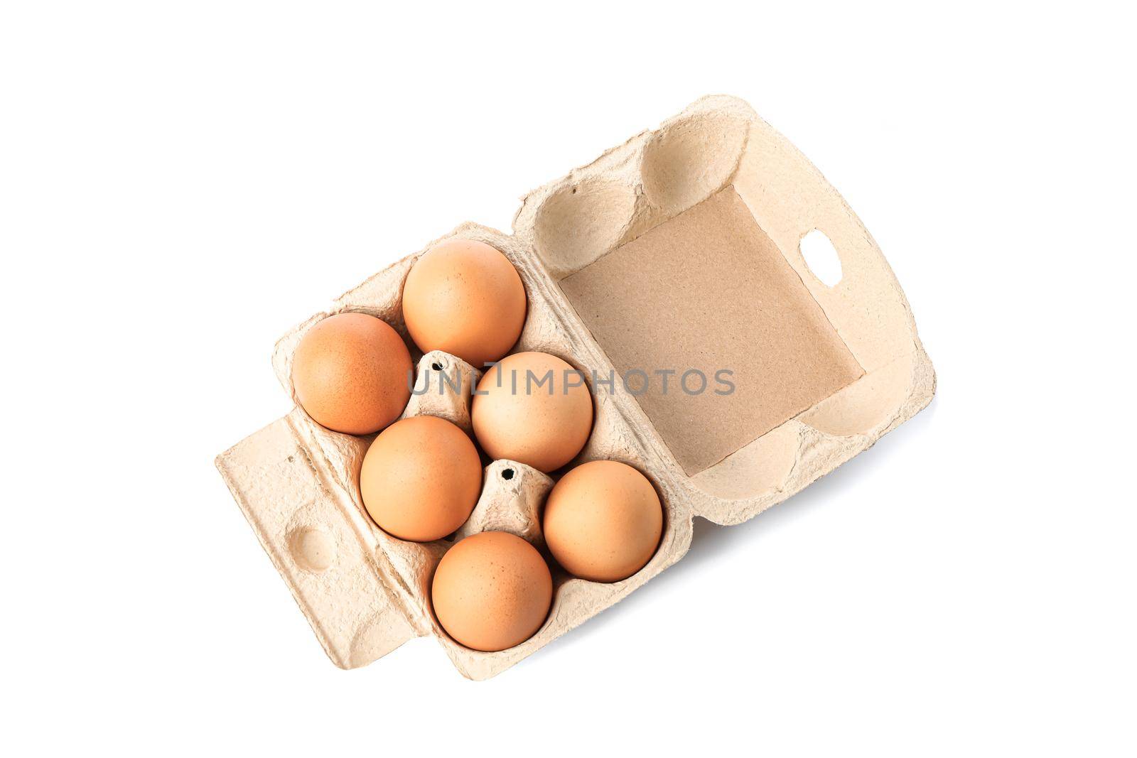 Brown chicken eggs in carton box isolated on white background. top view