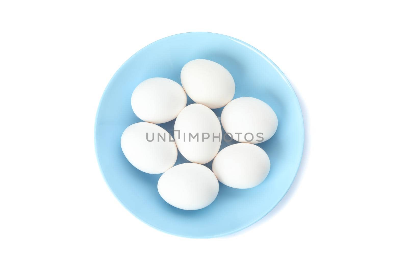 White chicken eggs in plate isolated on white background, top view