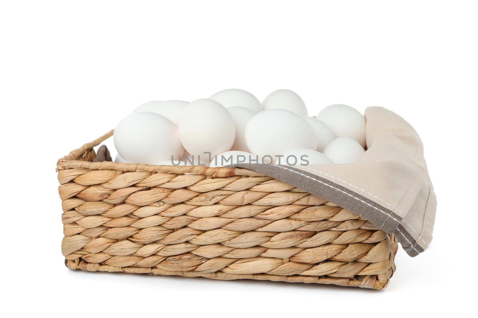 Chicken eggs in straw basket isolated on white background by AtlasCompany