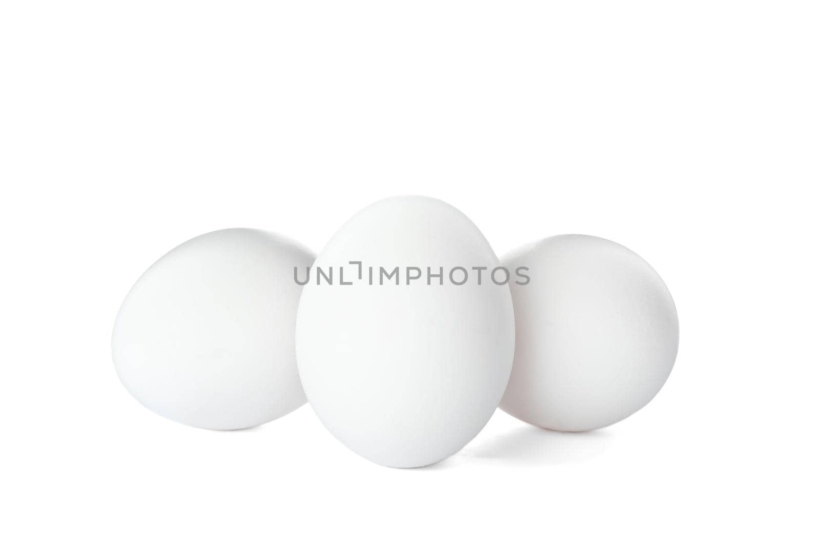 Few raw chicken eggs on white background by AtlasCompany