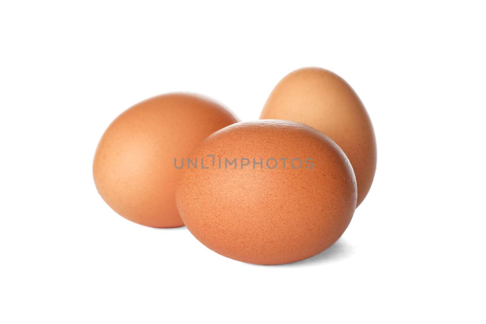 Few raw chicken eggs on white background by AtlasCompany