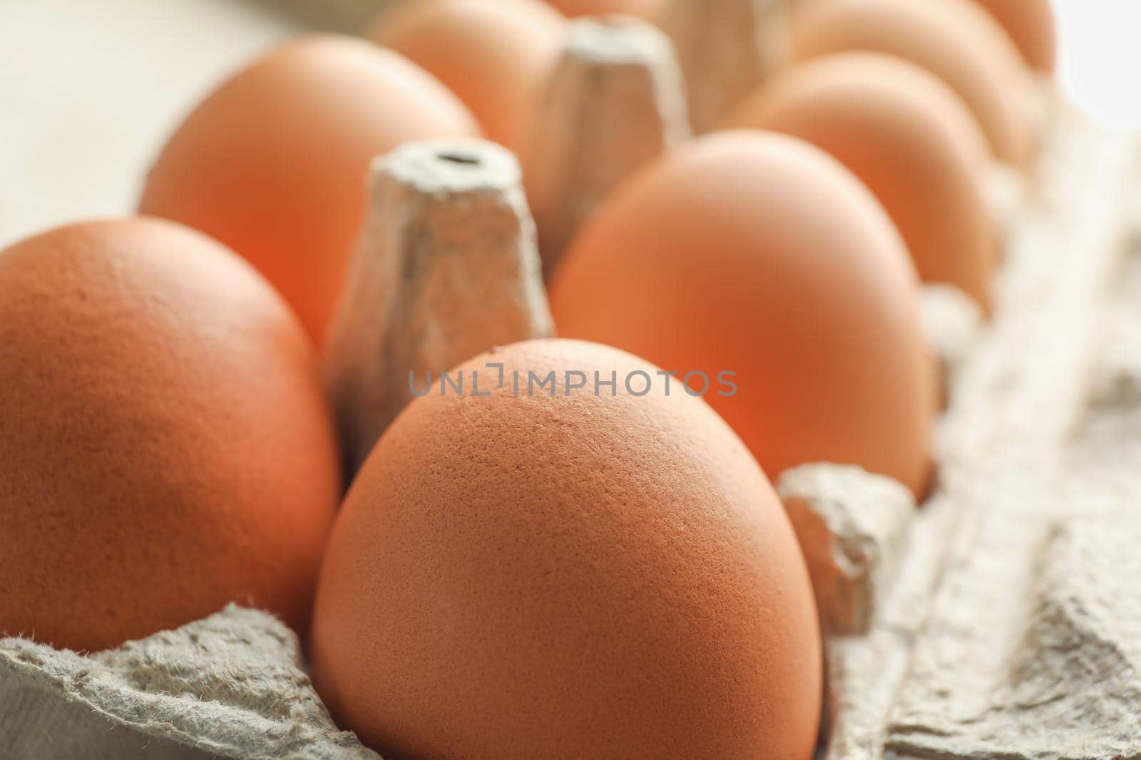 Chicken eggs in carton box as background, space for text