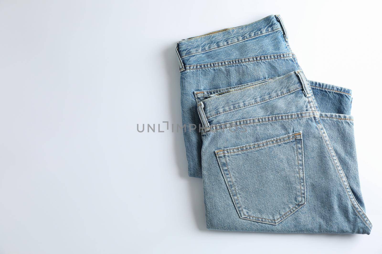 Jeans on white background, space for text