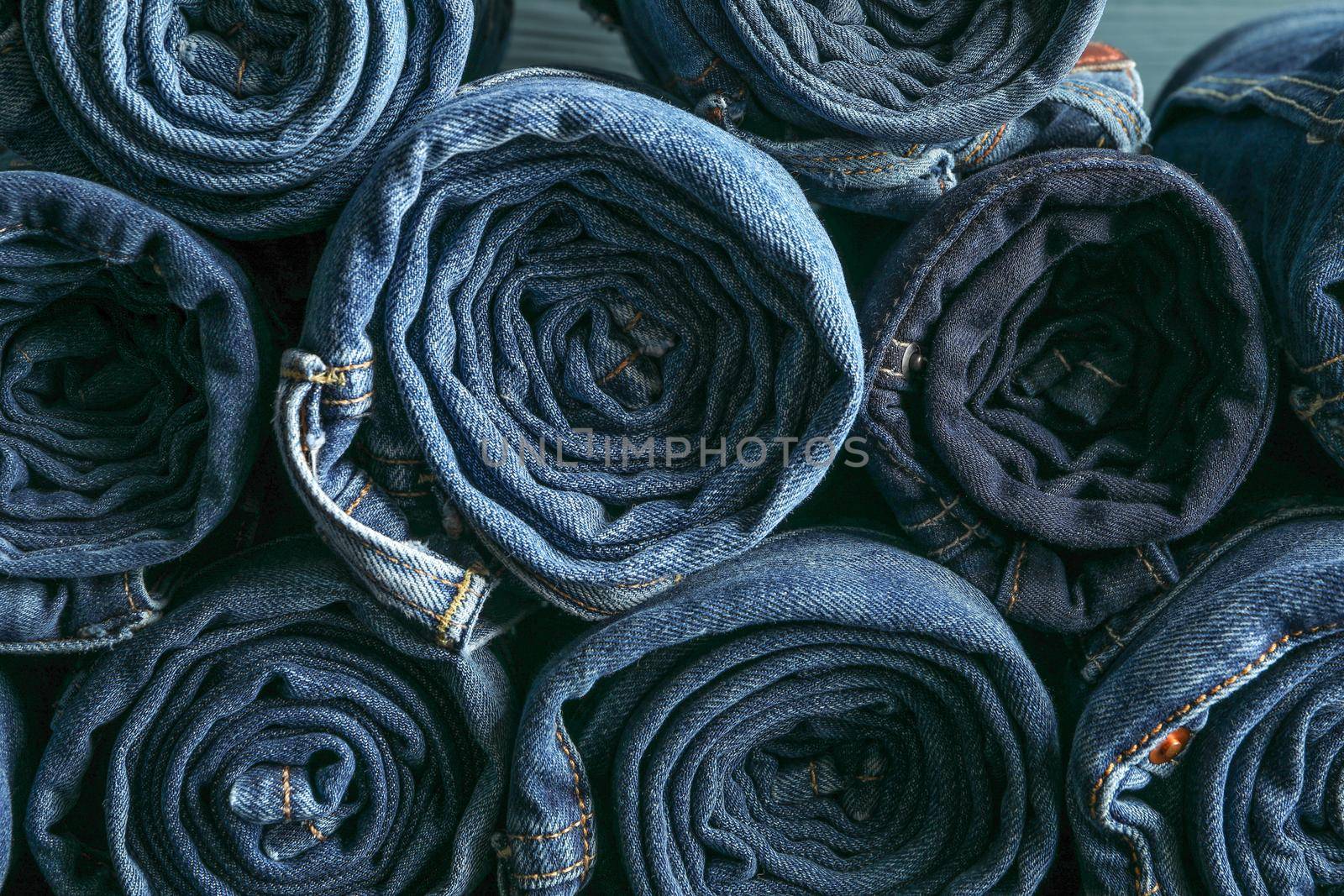 Background of a stack rolled jeans, space for text