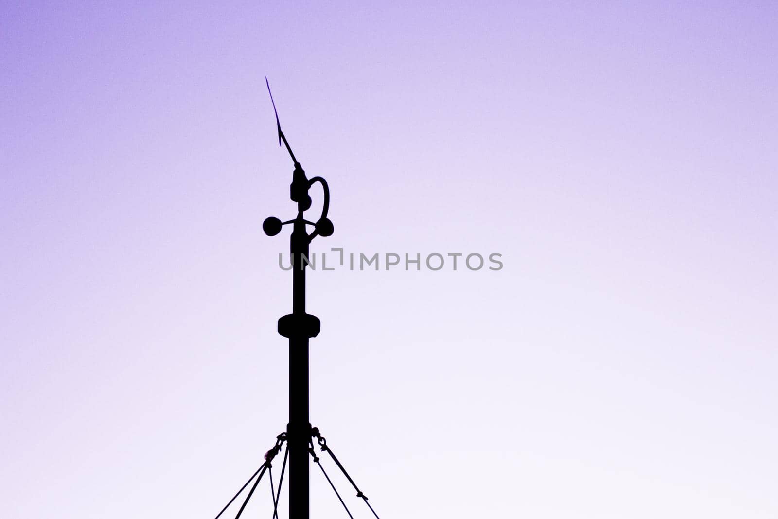 Weather station in silhouette over the sky at sunset. No people