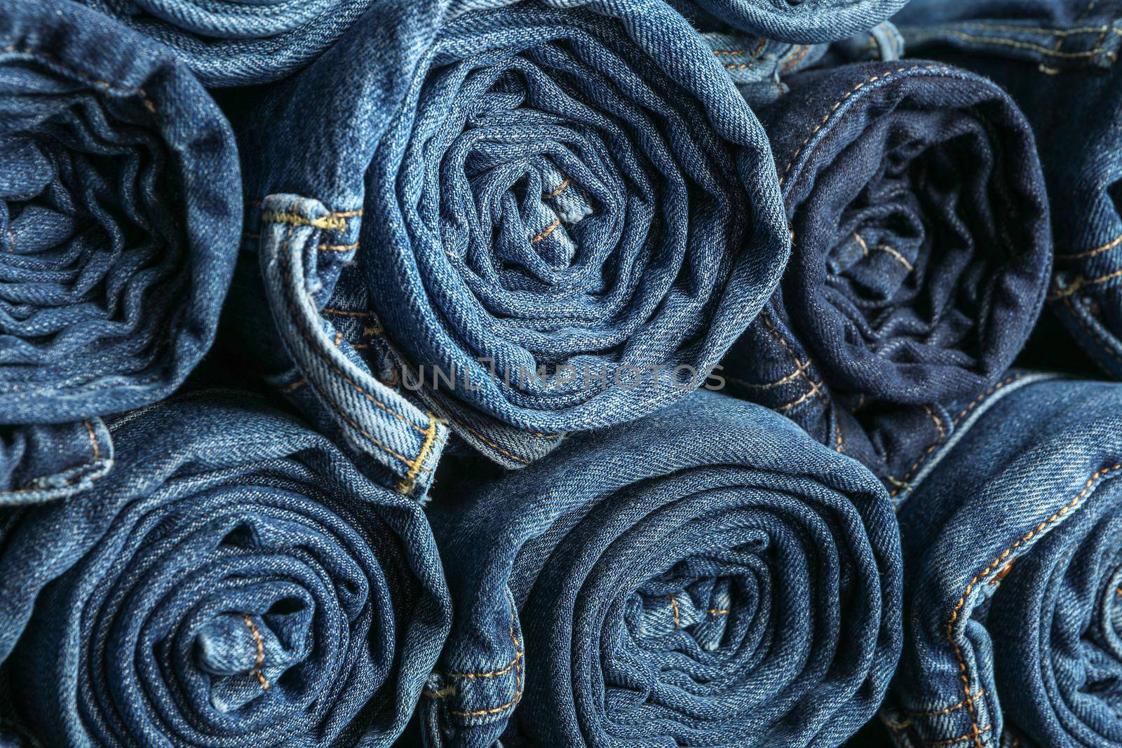 Background of a stack rolled jeans, space for text