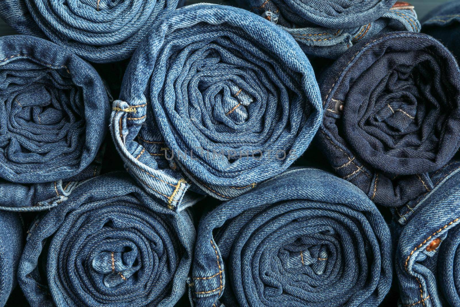 Background of a stack rolled jeans, space for text by AtlasCompany