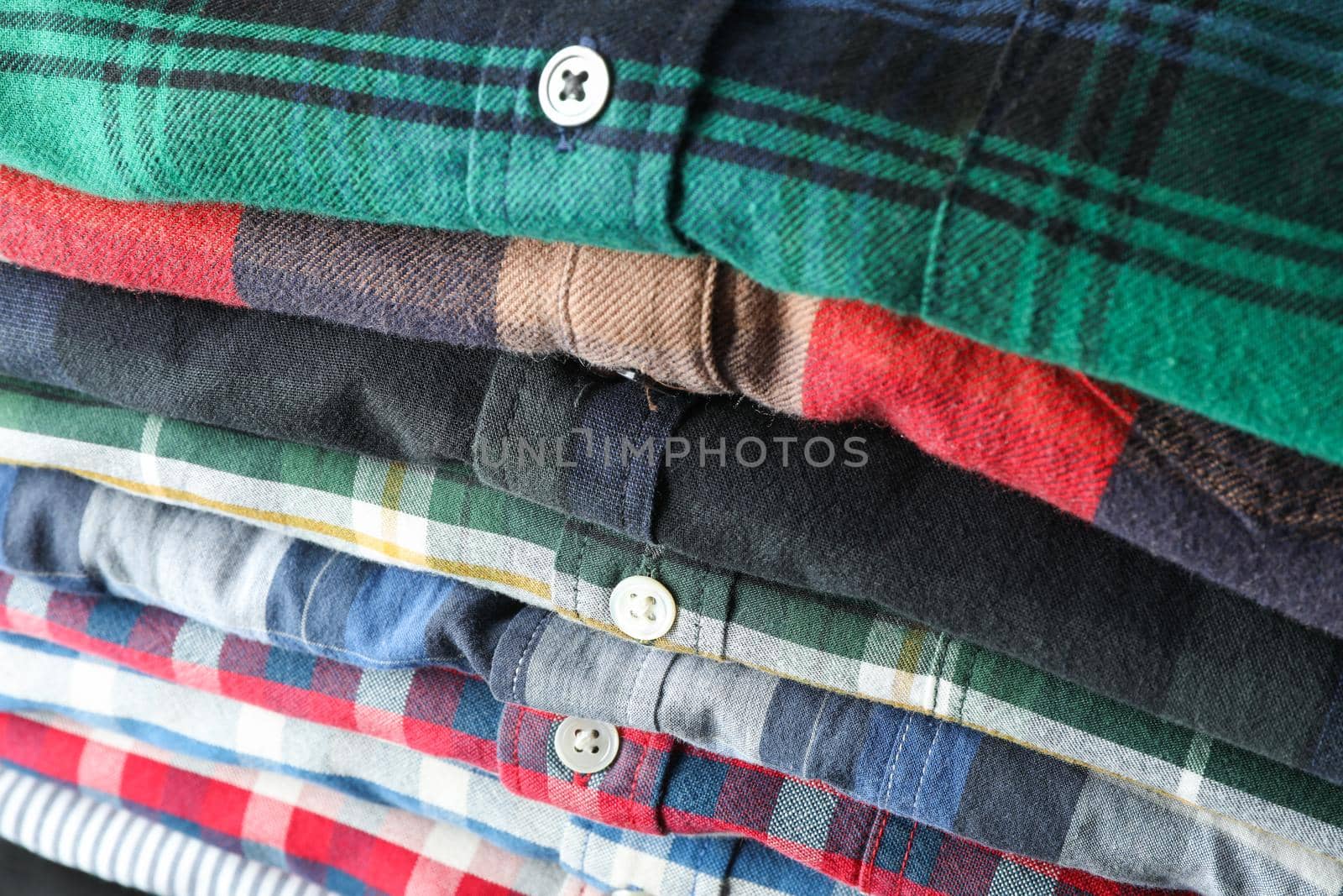 Stack of different shirts background, close up by AtlasCompany