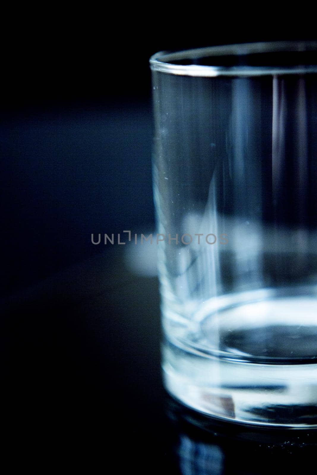 Empty glass transparent glass on dark background. Copy space