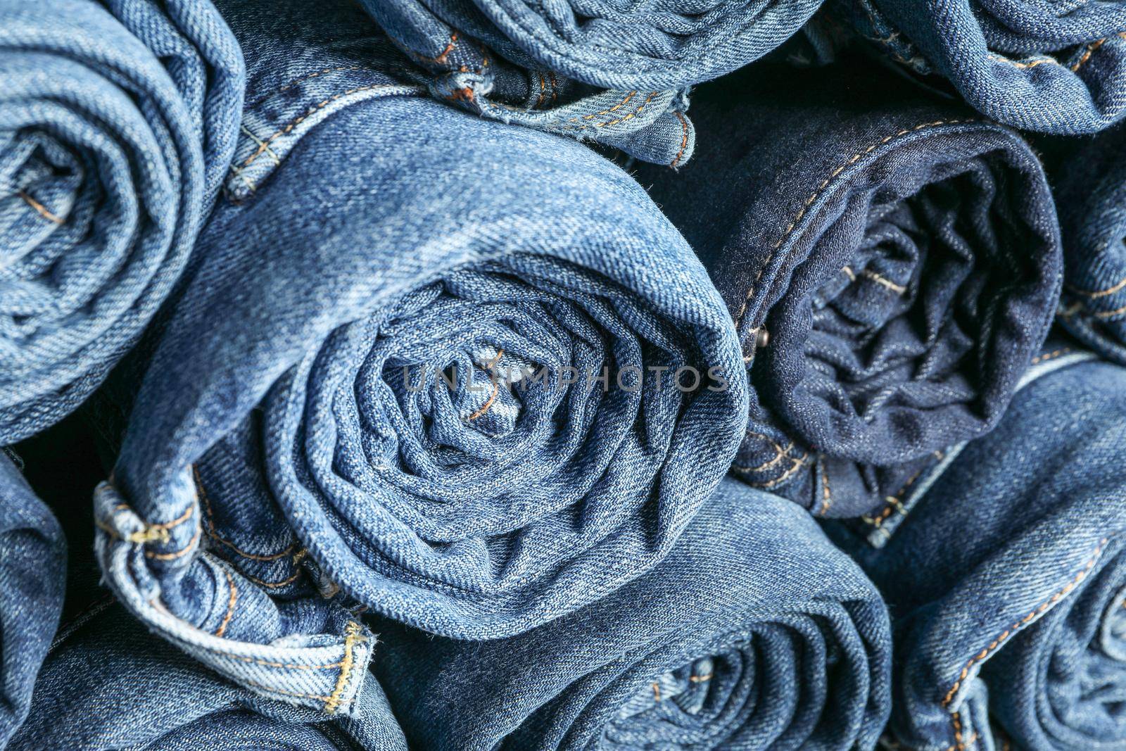 Background of a stack rolled jeans, space for text